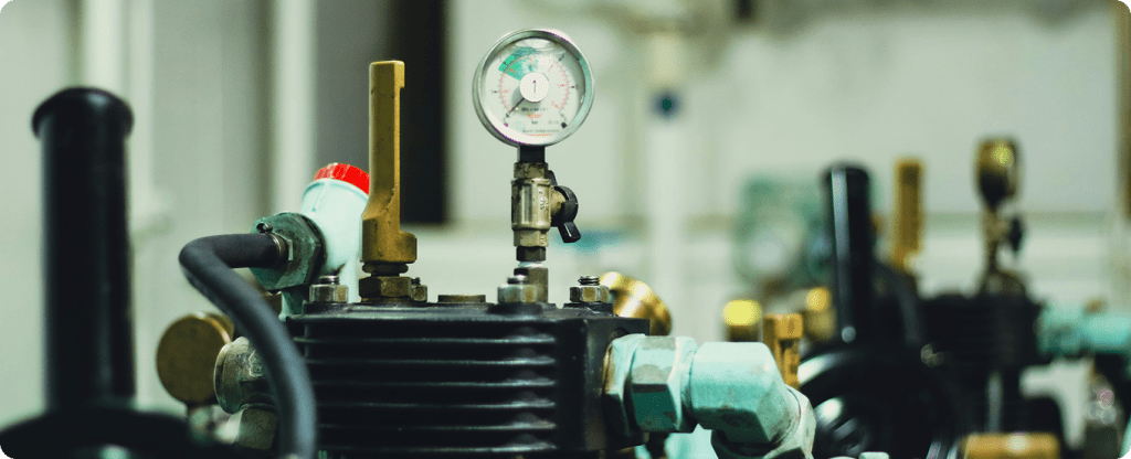 Mechanical HVAC equipment and pressure monitoring gauge for commercial heating and cooling systems.